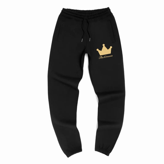 Black joggers with gold crown design on upper thigh of left leg.