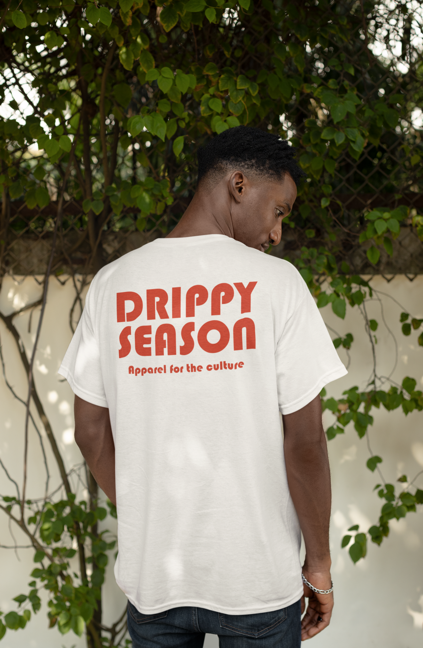 Man showing back of natural color t-shirt