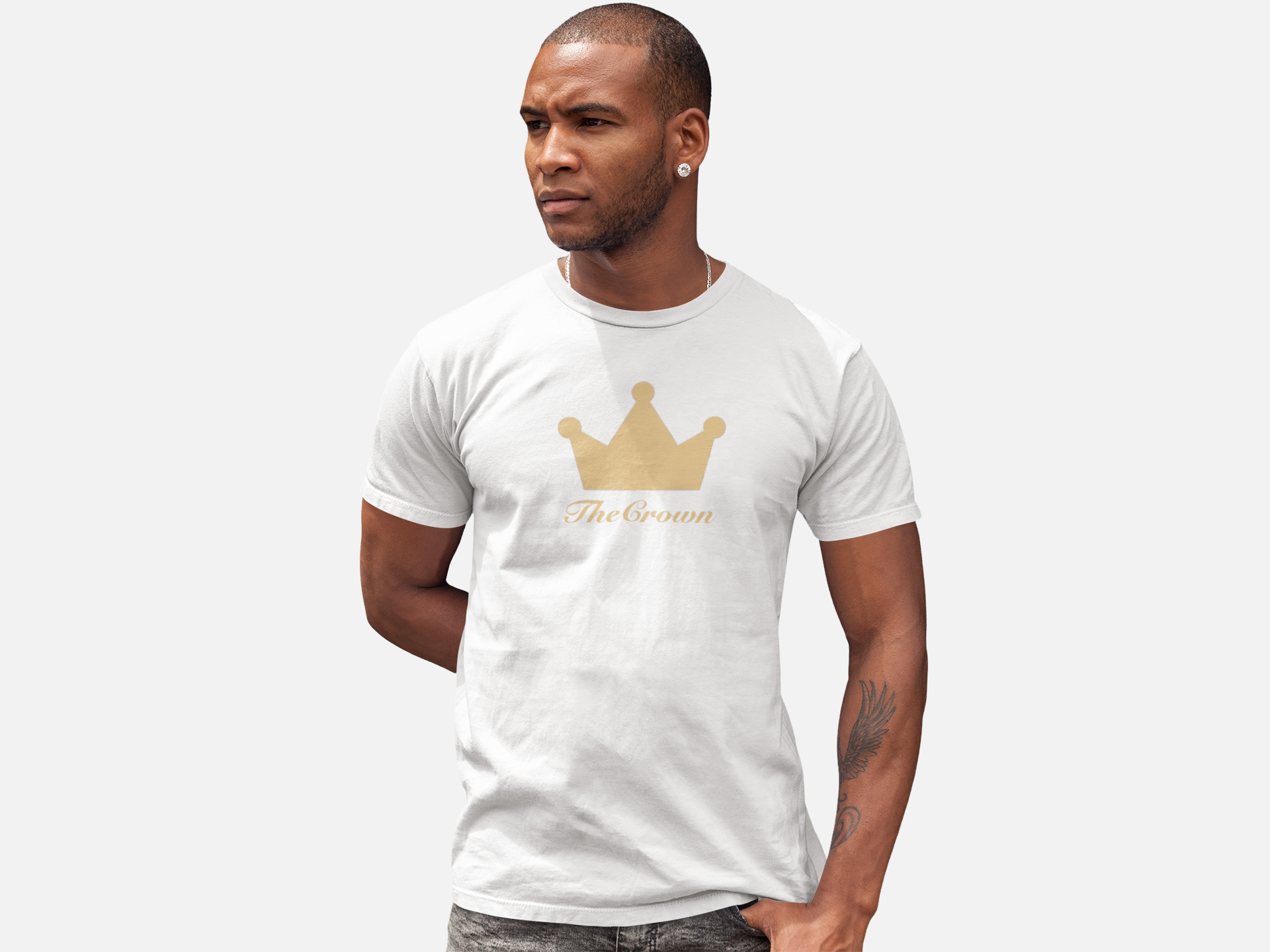 Man wearing white t-shirt with gold crown design on chest